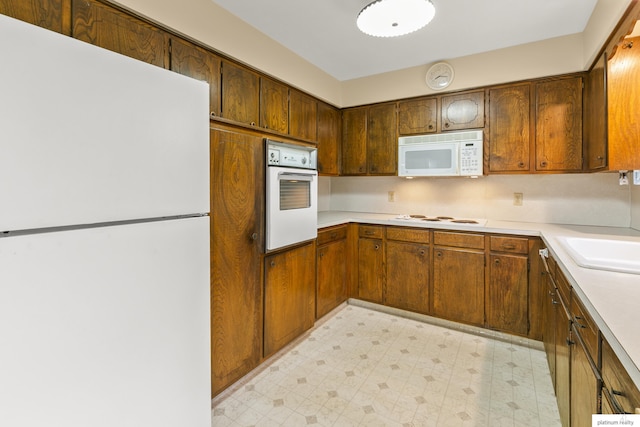 3809 N 94th St, Omaha, NE 68134 - kitchen with white appliances, light flooring, and light countertops