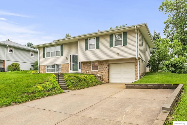 3809 N 94th St, Omaha, NE 68134 - raised ranch featuring brick siding, driveway, a front lawn, and an attached garage