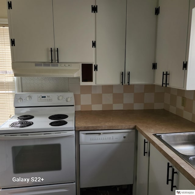 2134 S 48th St, Omaha, NE 68106 - kitchen with white appliances, under cabinet range hood, backsplash, and white cabinetry