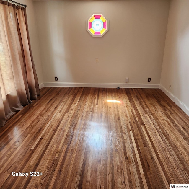 2134 S 48th St, Omaha, NE 68106 - spare room featuring baseboards and hardwood / wood-style floors