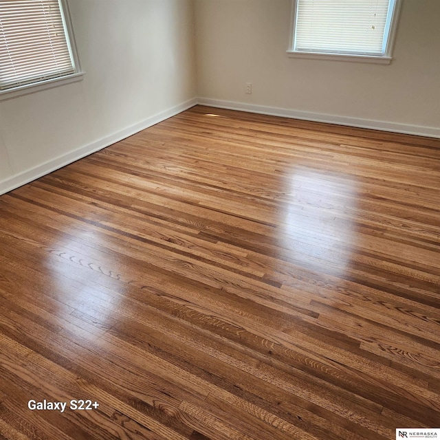 2134 S 48th St, Omaha, NE 68106 - unfurnished room with wood finished floors, healthy amount of natural light, and baseboards
