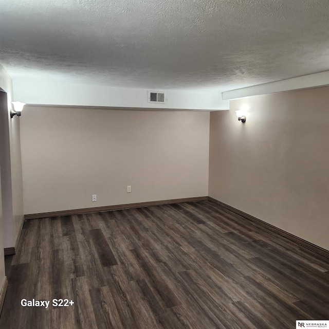 2134 S 48th St, Omaha, NE 68106 - spare room with dark wood finished floors, a textured ceiling, and baseboards