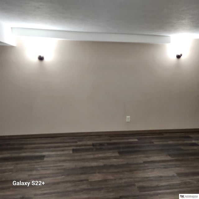 2134 S 48th St, Omaha, NE 68106 - unfurnished room with dark wood-style flooring and baseboards