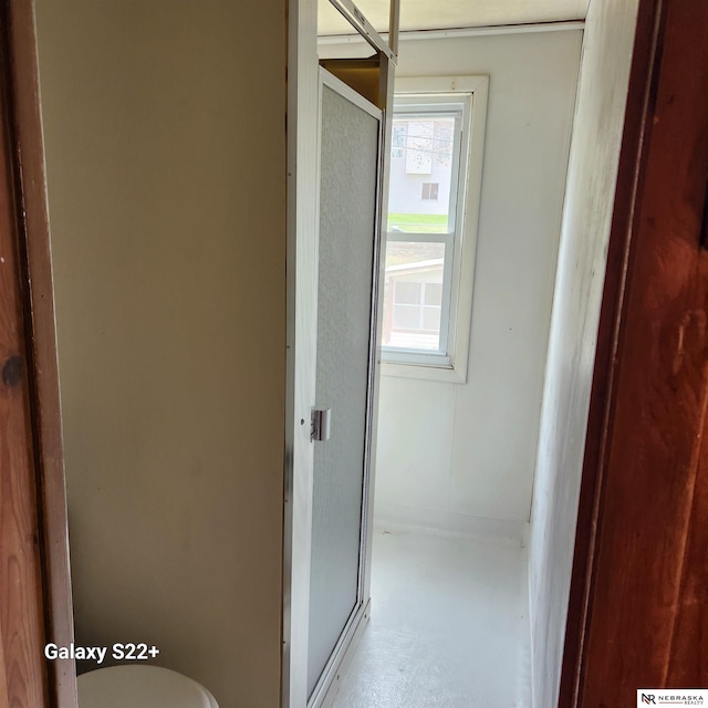 2134 S 48th St, Omaha, NE 68106 - bathroom featuring toilet, concrete floors, and an enclosed shower