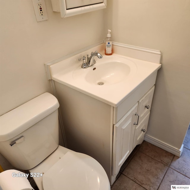 2134 S 48th St, Omaha, NE 68106 - half bathroom featuring vanity, toilet, and tile patterned floors
