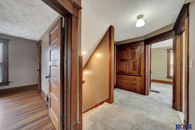 2524 S St, Lincoln, NE 68503 - hall with baseboards, a textured ceiling, and light colored carpet