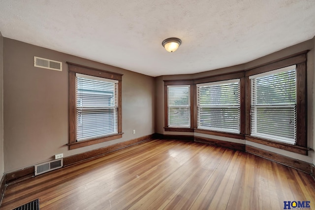 2524 S St, Lincoln, NE 68503 - spare room featuring baseboards and hardwood / wood-style floors