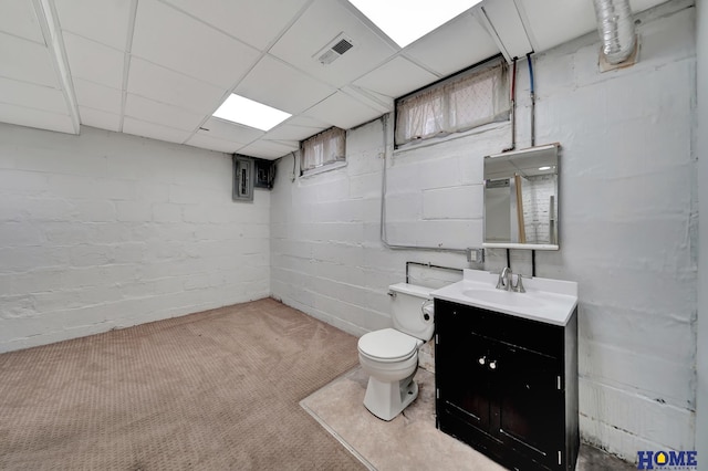 2524 S St, Lincoln, NE 68503 - bathroom featuring toilet, vanity, and concrete block wall