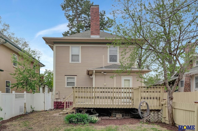 2524 S St, Lincoln, NE 68503 - rear view of house with a wooden deck, a chimney, and roof with shingles