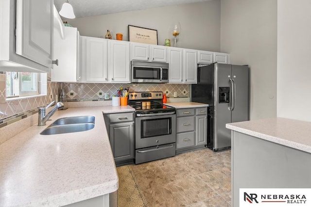 13518 Westport Cir, Bellevue, NE 68123 - kitchen featuring appliances with stainless steel finishes, a sink, tasteful backsplash, light countertops, and gray cabinetry