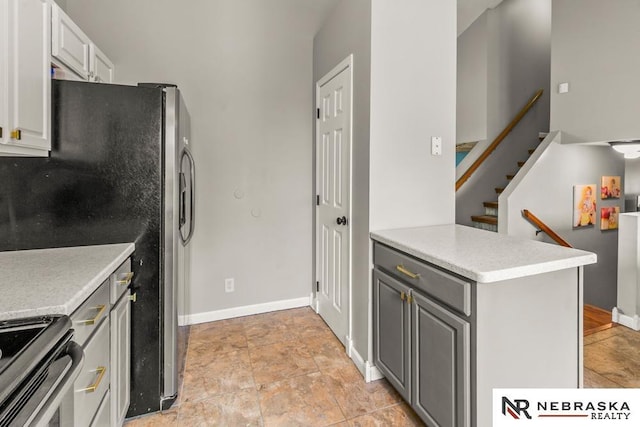 13518 Westport Cir, Bellevue, NE 68123 - kitchen featuring light countertops, gray cabinets, stainless steel appliances, and baseboards