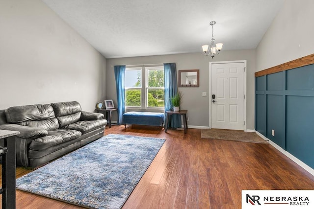 13518 Westport Cir, Bellevue, NE 68123 - living area featuring vaulted ceiling, a chandelier, and dark wood-type flooring