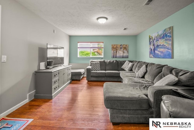 13518 Westport Cir, Bellevue, NE 68123 - living area featuring wood finished floors, a textured ceiling, and baseboards