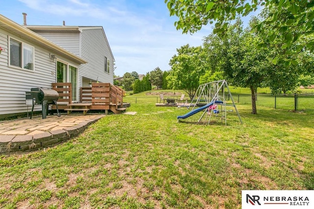 13518 Westport Cir, Bellevue, NE 68123 - view of yard featuring a deck and a playground