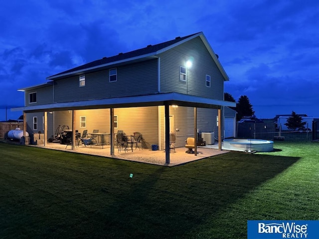 1646 Worms Rd, Saint Libory, NE 68872 - back of house at twilight with a patio area, cooling unit, and a jacuzzi