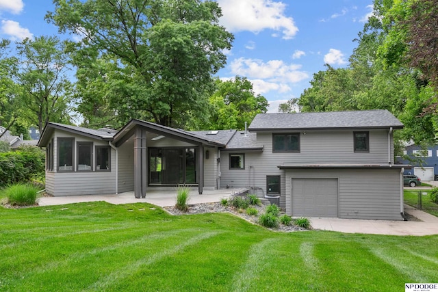 10615 Martha St, Omaha, NE 68124 - back of property featuring a yard, a garage, and a patio