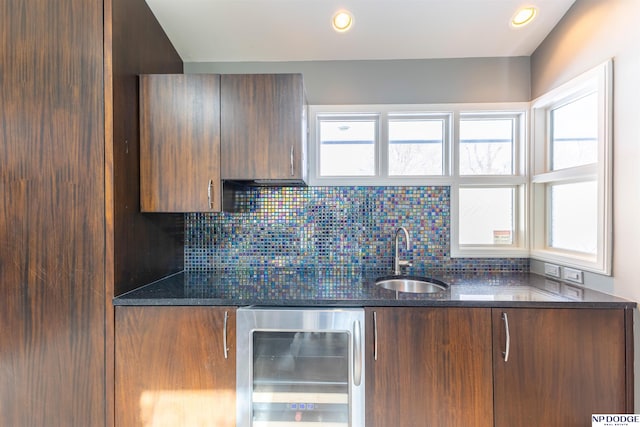 10615 Martha St, Omaha, NE 68124 - kitchen featuring beverage cooler, a sink, dark stone countertops, backsplash, and recessed lighting