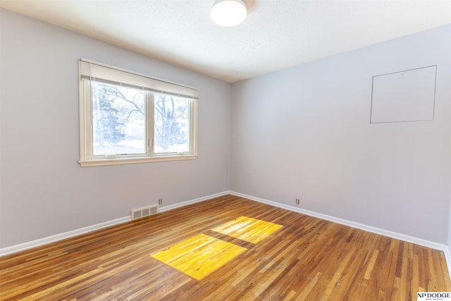 10615 Martha St, Omaha, NE 68124 - unfurnished room with baseboards and light wood finished floors