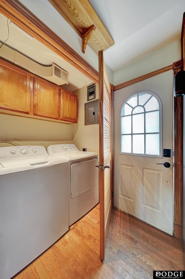 3317 N 9th St, Lincoln, NE 68521 - washroom with cabinet space, washing machine and dryer, light wood-style floors, and electric panel