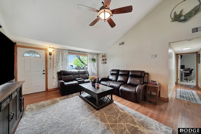 3317 N 9th St, Lincoln, NE 68521 - living area featuring wood finished floors, high vaulted ceiling, ceiling fan, and baseboards