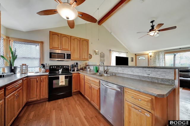 3317 N 9th St, Lincoln, NE 68521 - kitchen featuring stainless steel appliances, a sink, ceiling fan, and a peninsula