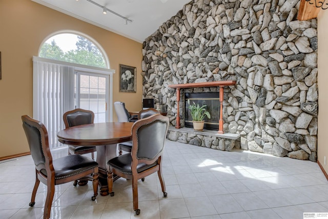 4459 F St, Omaha, NE 68107 - dining space featuring a fireplace, track lighting, tile patterned floors, and lofted ceiling