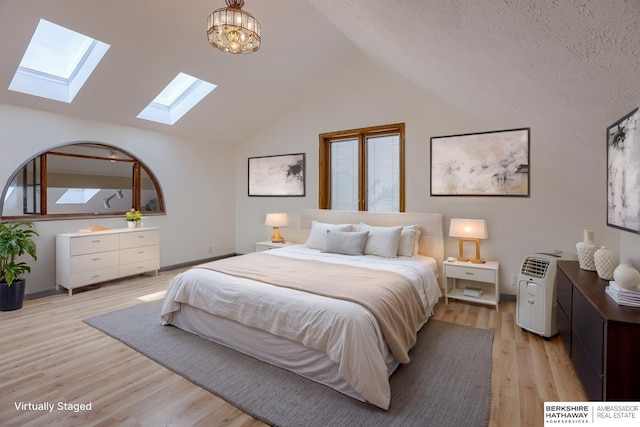 4459 F St, Omaha, NE 68107 - bedroom featuring a skylight, light wood-style flooring, and vaulted ceiling