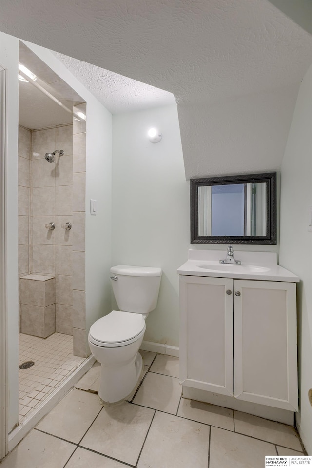 4459 F St, Omaha, NE 68107 - full bathroom with toilet, vanity, a tile shower, tile patterned floors, and a textured ceiling