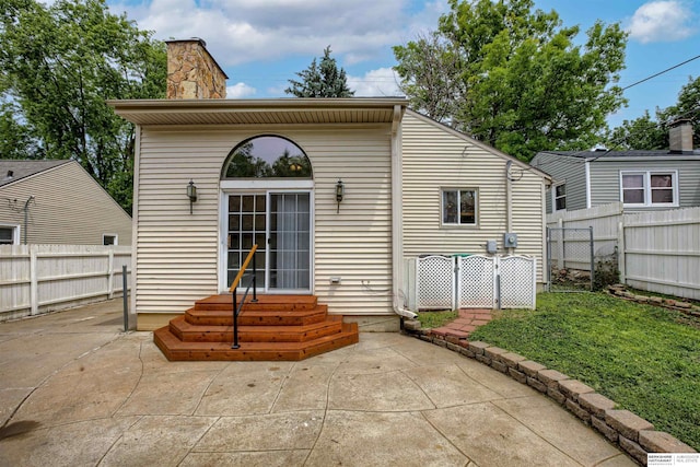 4459 F St, Omaha, NE 68107 - rear view of property with a patio, entry steps, and a chimney