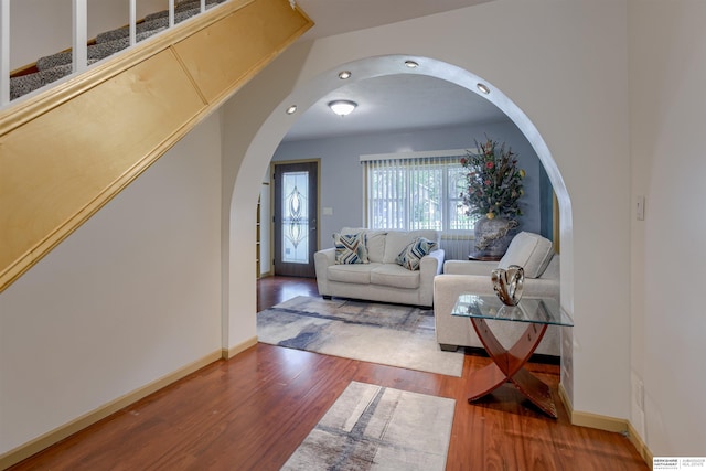 4459 F St, Omaha, NE 68107 - living room with arched walkways, wood finished floors, and baseboards