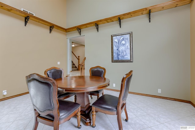 4459 F St, Omaha, NE 68107 - dining room featuring stairway, baseboards, and light tile patterned floors