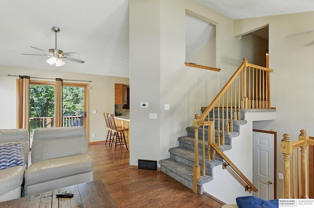 8853 N 82nd Ave, Omaha, NE 68122 - living area with a ceiling fan, wood finished floors, baseboards, and stairway