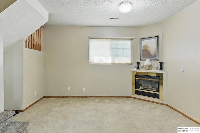 8853 N 82nd Ave, Omaha, NE 68122 - unfurnished living room with carpet floors, a textured ceiling, baseboards, and a tiled fireplace