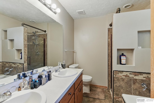 8853 N 82nd Ave, Omaha, NE 68122 - full bathroom featuring a stall shower, double vanity, toilet, and a textured ceiling