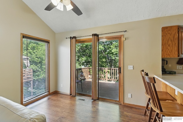 8853 N 82nd Ave, Omaha, NE 68122 - doorway to outside with lofted ceiling, ceiling fan, light wood-type flooring, healthy amount of natural light, and baseboards