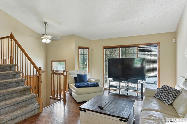 8853 N 82nd Ave, Omaha, NE 68122 - living room with wood-type flooring, ceiling fan, a textured ceiling, and stairs