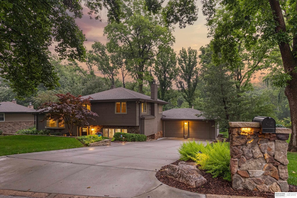 3275 Bridgeford Rd, Omaha, NE 68124 - view of front of property featuring a chimney, a garage, and a yard