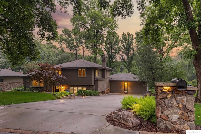 3275 Bridgeford Rd, Omaha, NE 68124 - view of front of property featuring a chimney, a garage, and a yard