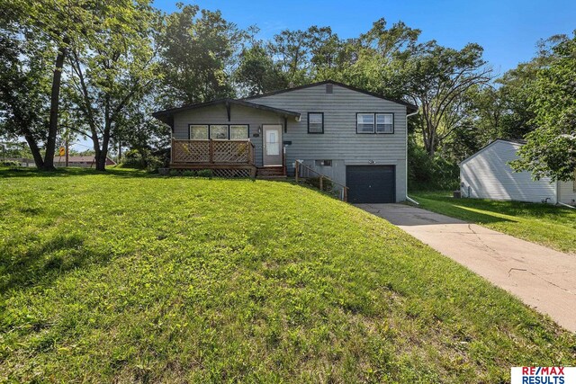 5704 N 68th St, Omaha, NE 68104 - split level home featuring an attached garage, driveway, and a front yard
