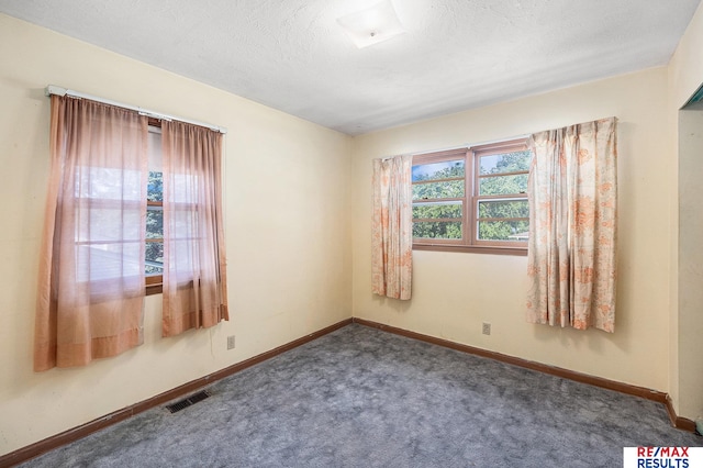 5704 N 68th St, Omaha, NE 68104 - carpeted empty room featuring baseboards and a textured ceiling