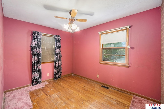 5704 N 68th St, Omaha, NE 68104 - spare room with wood finished floors, ceiling fan, and baseboards