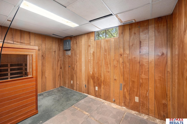 5704 N 68th St, Omaha, NE 68104 - basement featuring wood walls, carpet flooring, and a drop ceiling