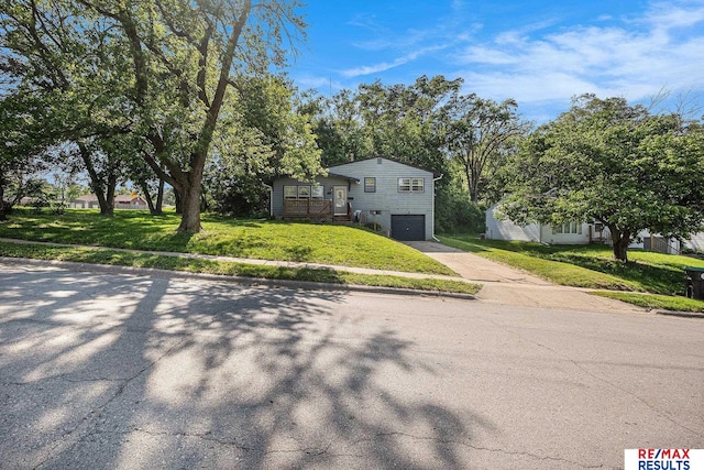 5704 N 68th St, Omaha, NE 68104 - view of front of home with a garage, concrete driveway, and a front lawn