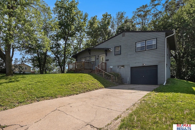 5704 N 68th St, Omaha, NE 68104 - split level home with an attached garage, a front yard, concrete driveway, and a wooden deck