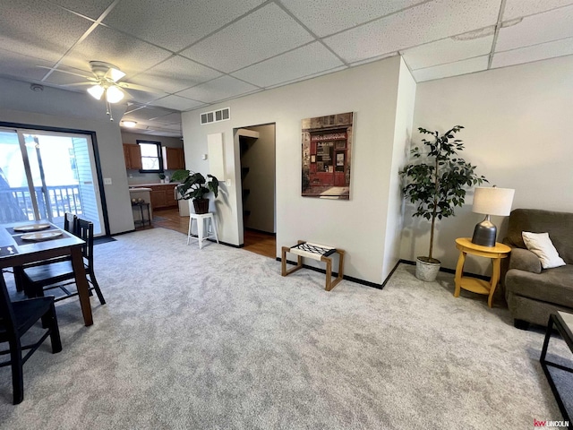 1402 Rose St, Lincoln, NE 68502 - carpeted living room featuring a paneled ceiling, a ceiling fan, and baseboards