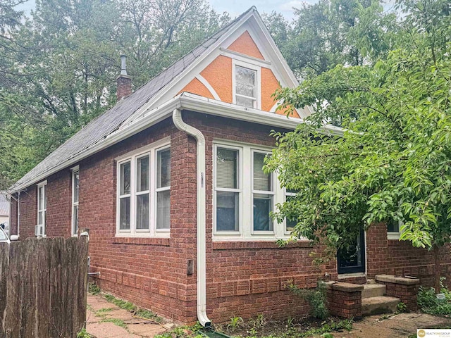 4710 S 17th St, Omaha, NE 68107 - view of property exterior with brick siding and a chimney