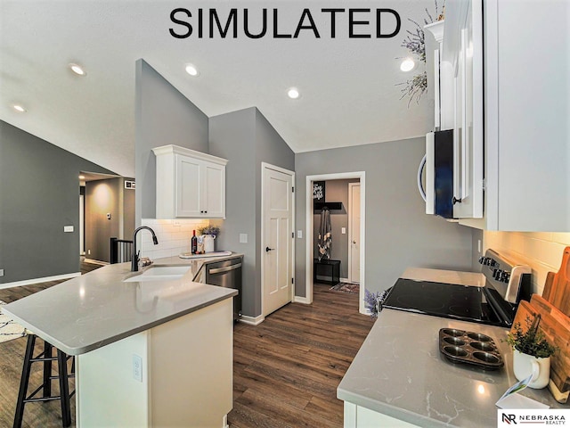 4048 Northview Dr, Grand Island, NE 68803 - kitchen featuring a sink, stainless steel appliances, dark wood finished floors, decorative backsplash, and a peninsula