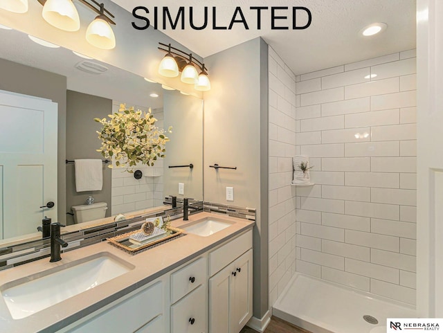 4048 Northview Dr, Grand Island, NE 68803 - bathroom with double vanity, toilet, tiled shower, and recessed lighting