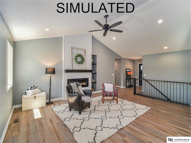 4048 Northview Dr, Grand Island, NE 68803 - living area featuring an upstairs landing, wood finished floors, baseboards, vaulted ceiling, and a large fireplace