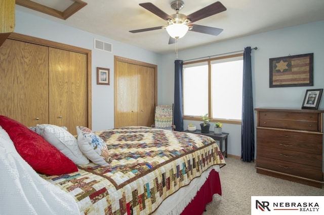 13410 Highlander Pl, Waverly, NE 68462 - bedroom featuring two closets, light colored carpet, and ceiling fan